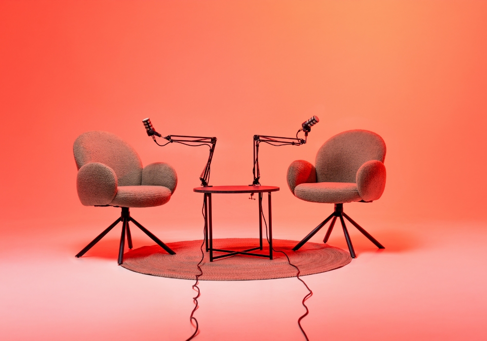 Two empty chairs face microphones, illustrating that RamPaige DV-MRT is a 24-module program that includes weekly group sessions to share and discuss what you've learned from your homework.